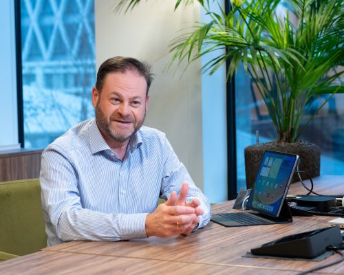 Kris legt uit achter zijn bureau